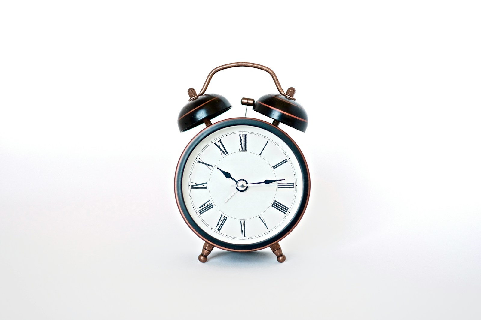 round black and white analog alarm clock